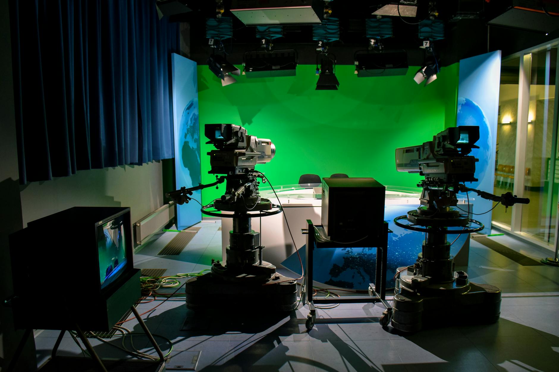 TV studio setup with cameras and green screen — the apparatus of reality television production