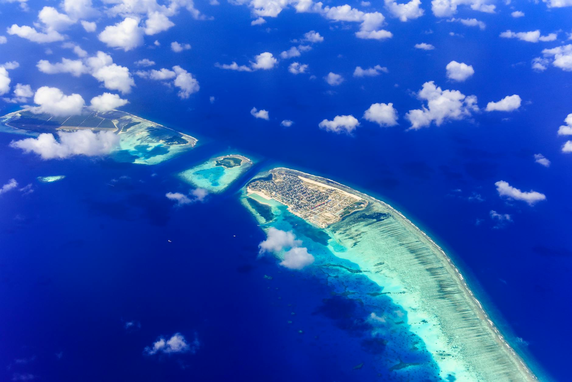 Aerial view of tropical islands surrounded by turquoise lagoon, Indian Ocean atoll