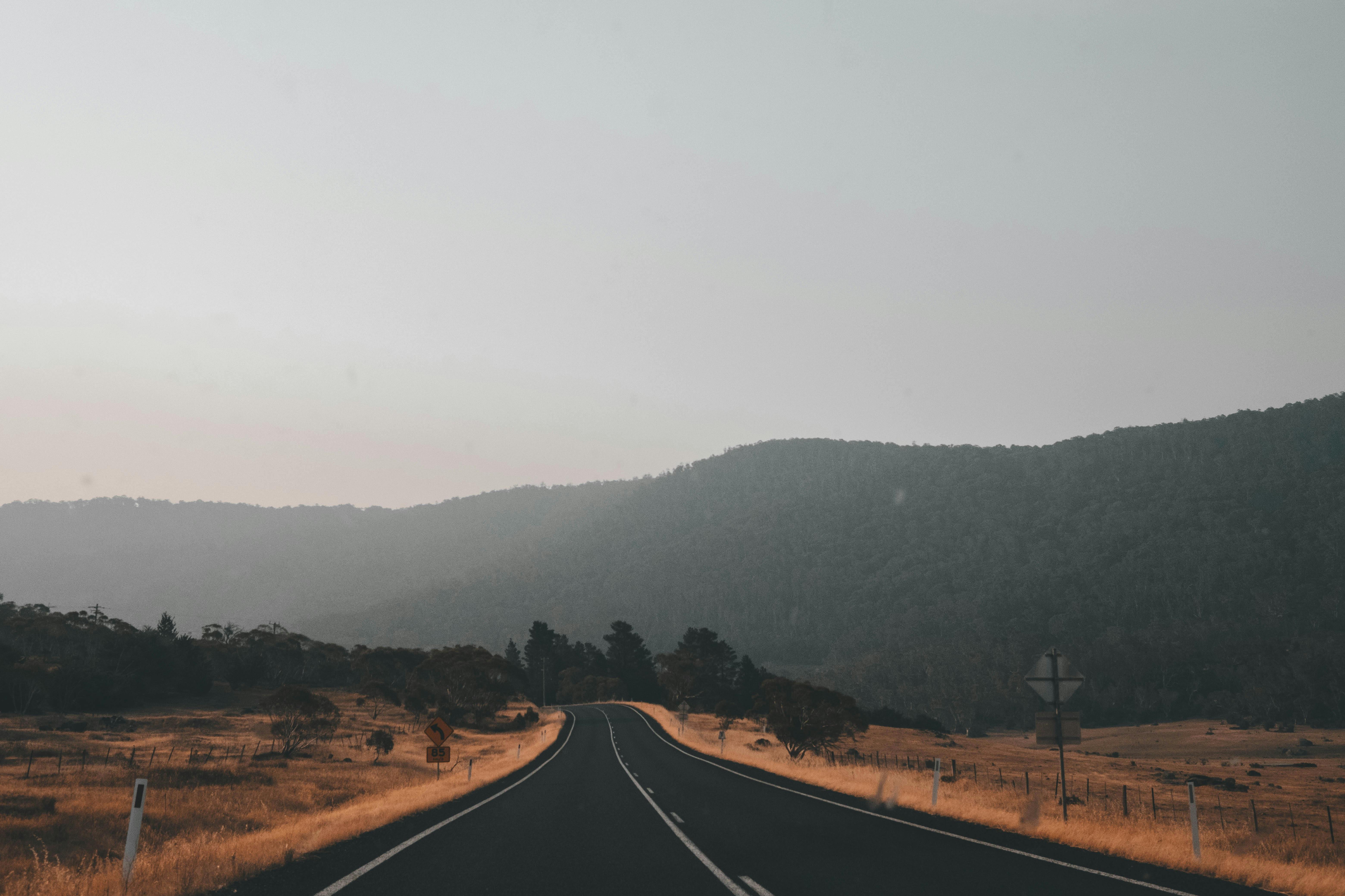 A tranquil road through scenic Australian countryside near Thredbo, NSW — perfect for a weekend road trip escape