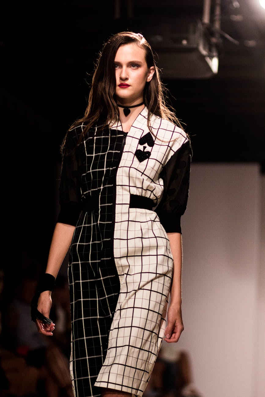 A model walks the runway in a checked dress