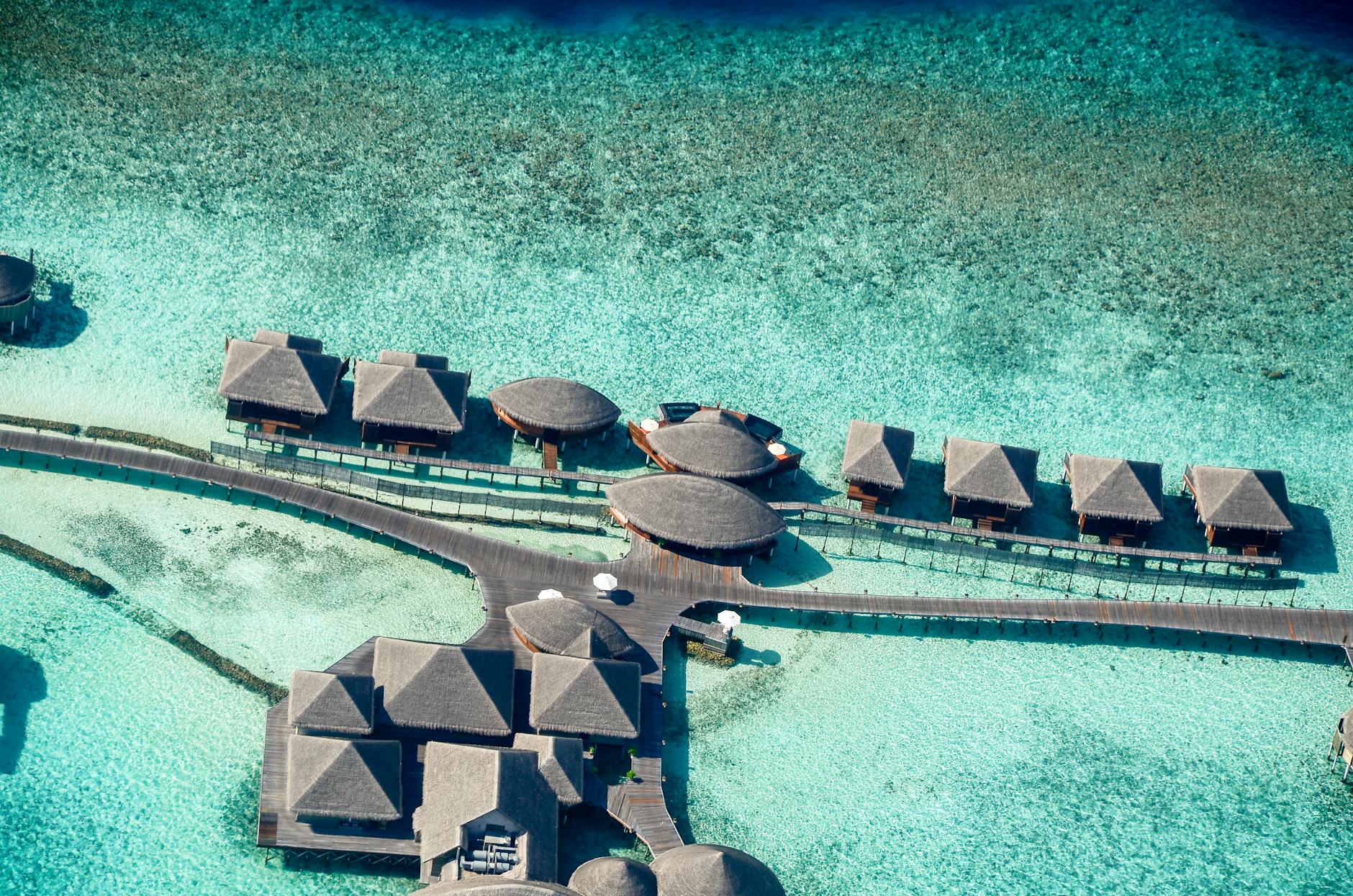 Aerial view of overwater villas in the Maldives, the polished fantasy Australians have long filed under too-hard.