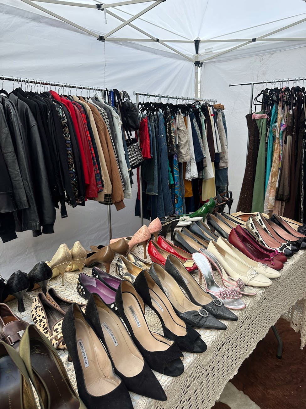 Vintage clothing and shoes arranged at a fashion-market stall