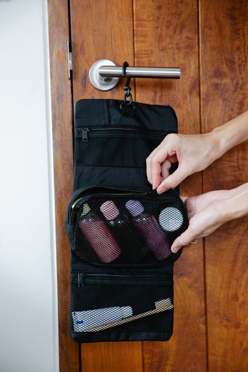 Travel toiletries and beauty essentials spread out before packing.