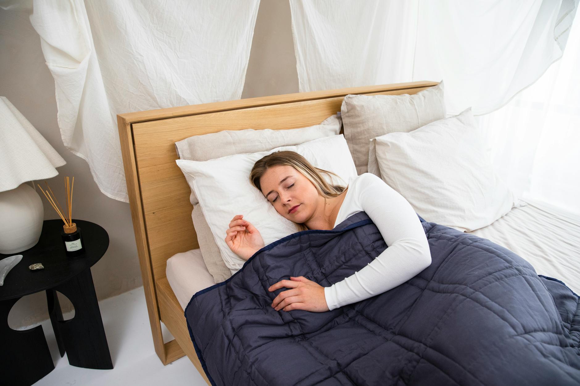 A weighted blanket laid across a bed.
