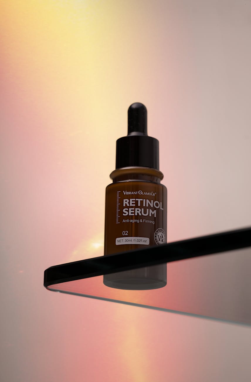 Skincare serum bottles and droppers on a clean white surface with soft botanical styling