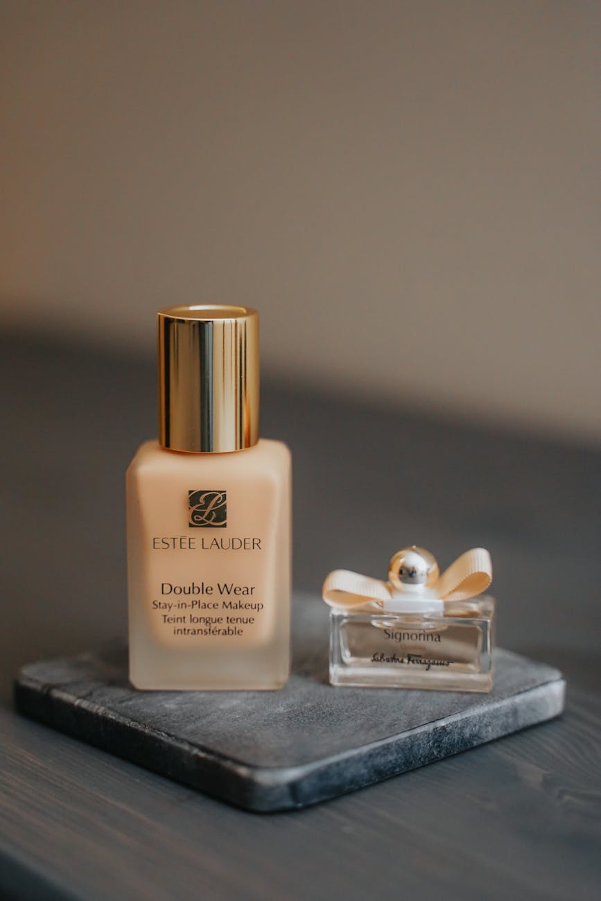 Close-up beauty display featuring Estée Lauder foundation and fragrance bottles, used to illustrate luxury beauty scale and brand identity.