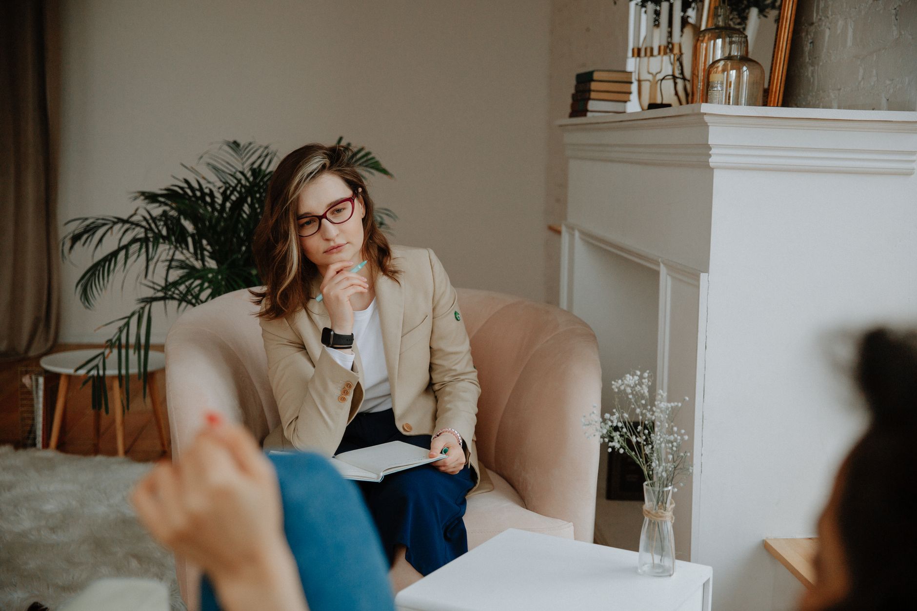 A therapist listening during a counselling session, reflecting the intimate scale of mental health care behind the global numbers.