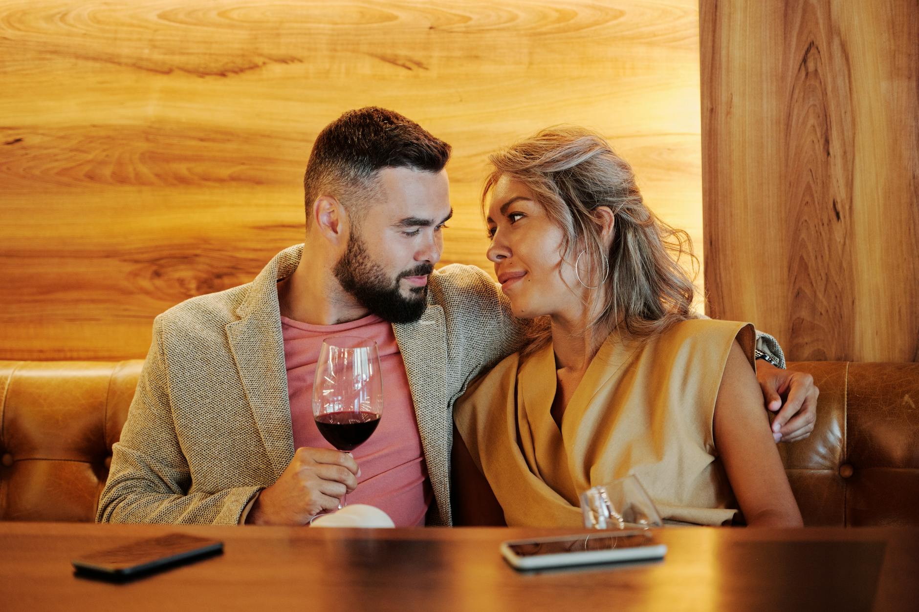 A couple sitting together on a first date, illustrating the emotional politics of paying the bill
