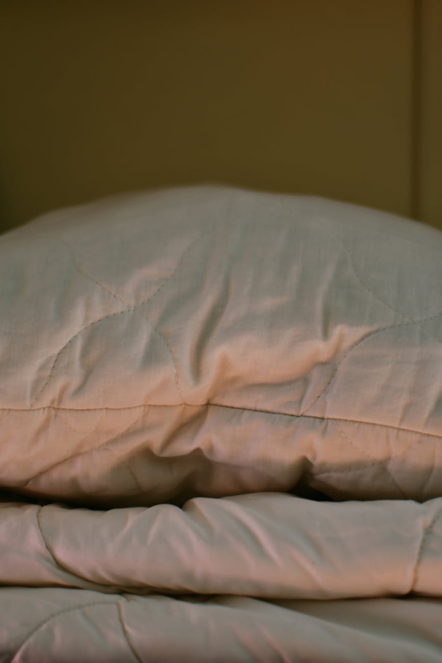 Sleep setting with natural textures, used as hero art for a feature about wool mattresses and thermal comfort.