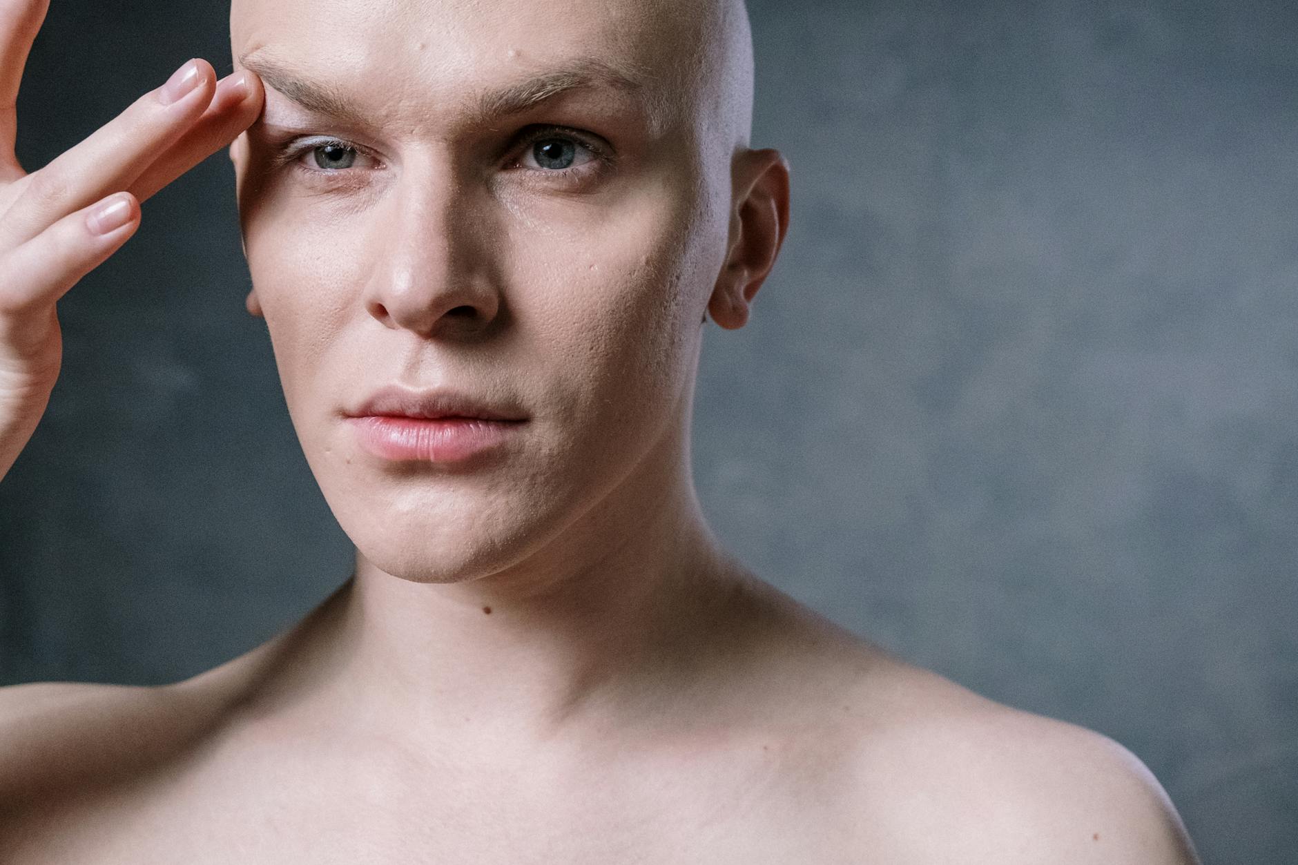 Close-up of a man applying makeup with a brush