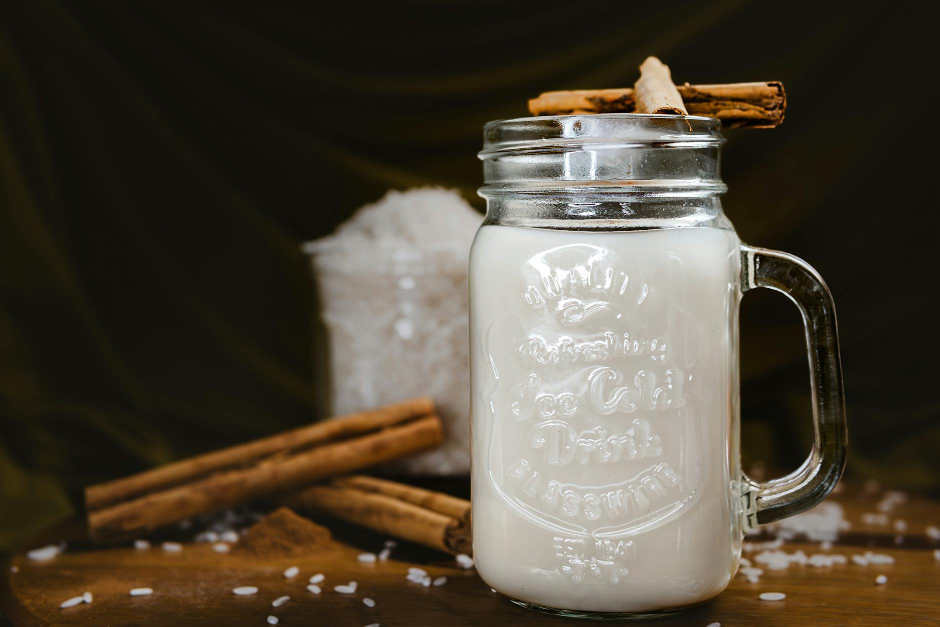 A chilled glass of horchata with cinnamon sticks, echoing the cold creamy café drink at the centre of the story