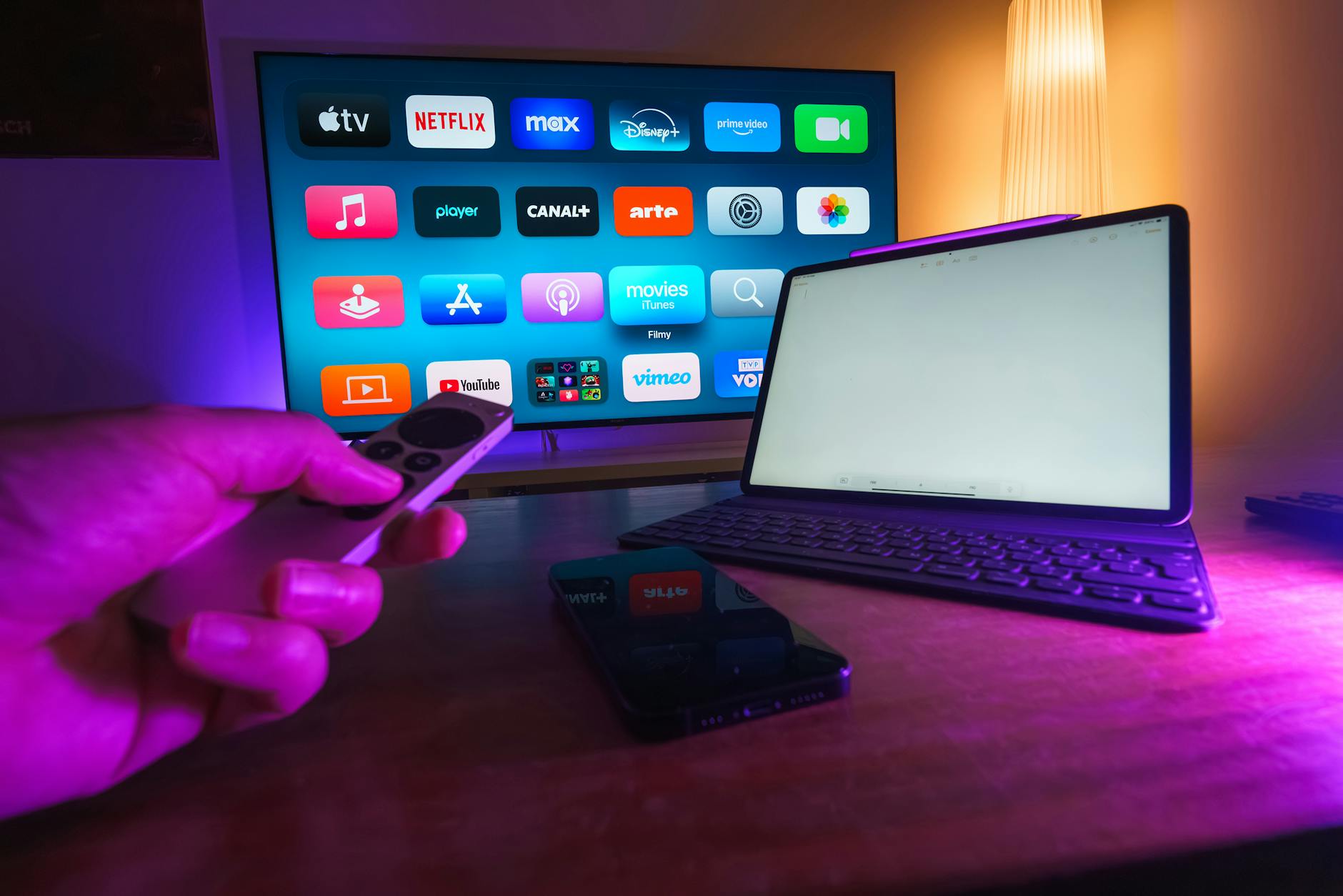 Streaming apps displayed across a television screen in a dark living room