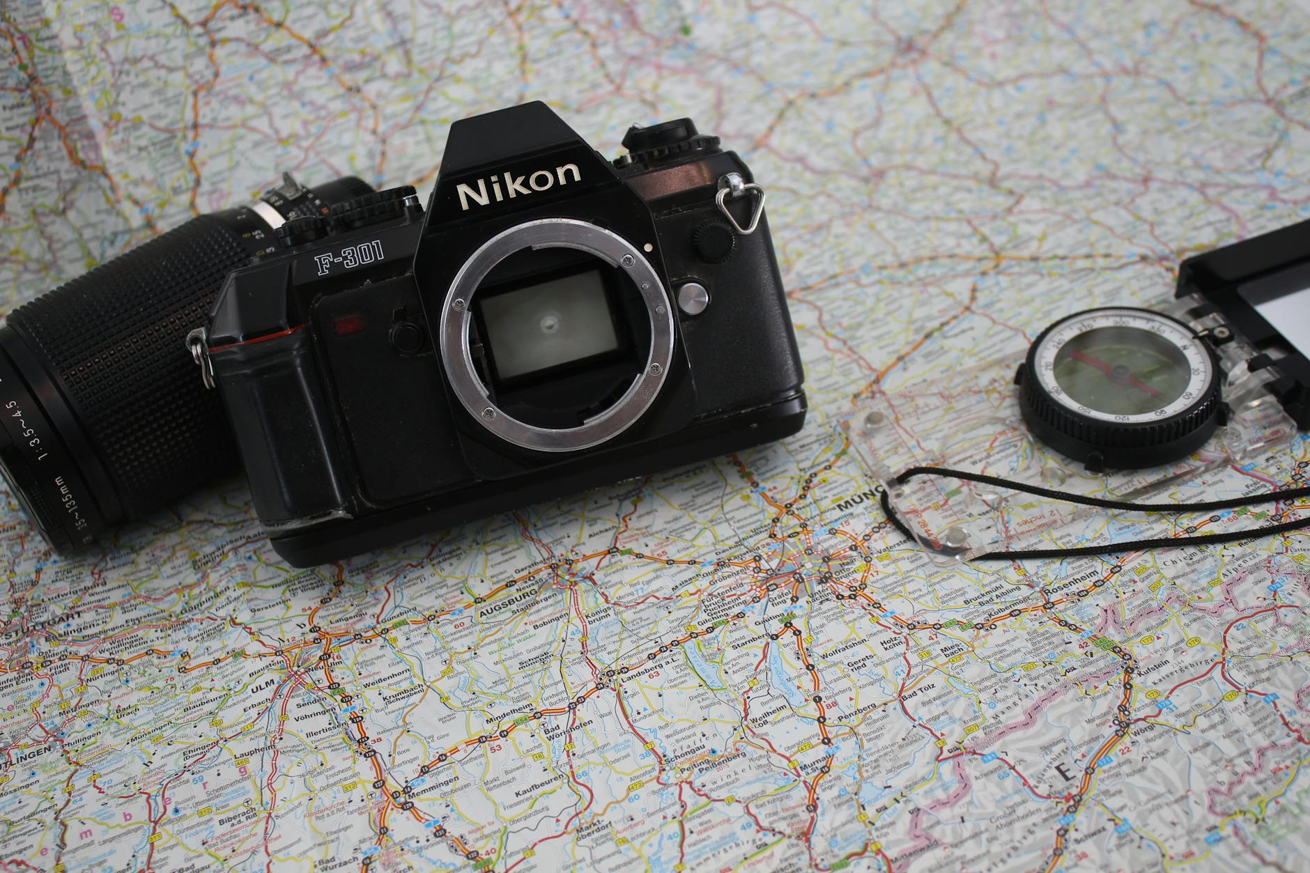 Vintage camera resting on a folded travel map, a visual case for swapping apps for dedicated travel tools