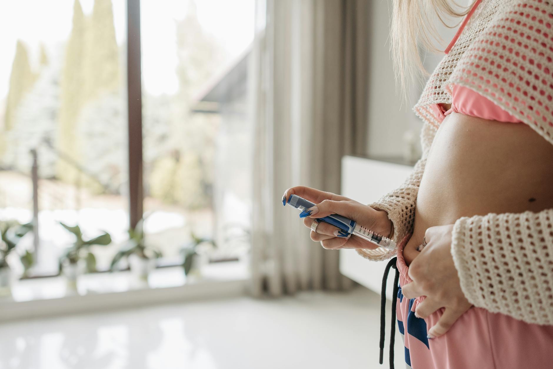 Woman using an injection pen at home.