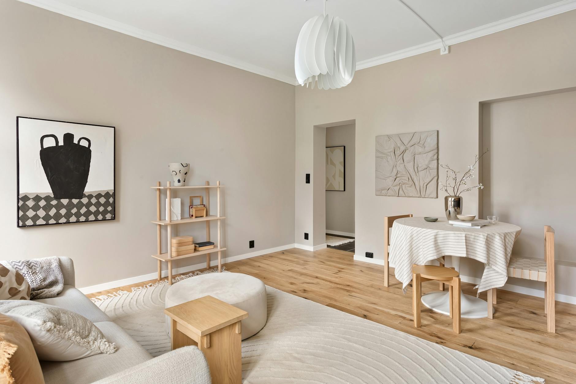 A neutral living room where beige walls, pale upholstery and soft curves blur into one polished mood.