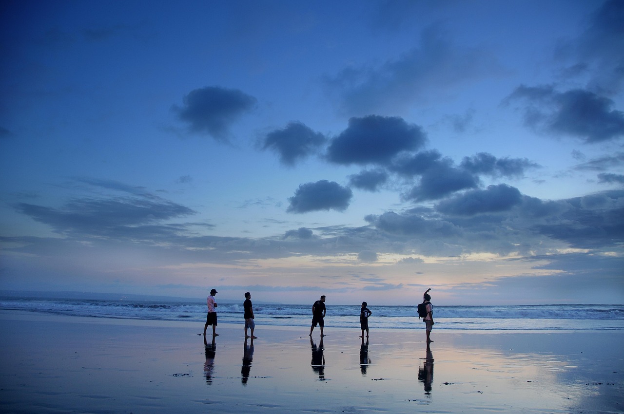 Families and travellers on a Bali beach, the ordinary holiday at the centre of Australia's status argument