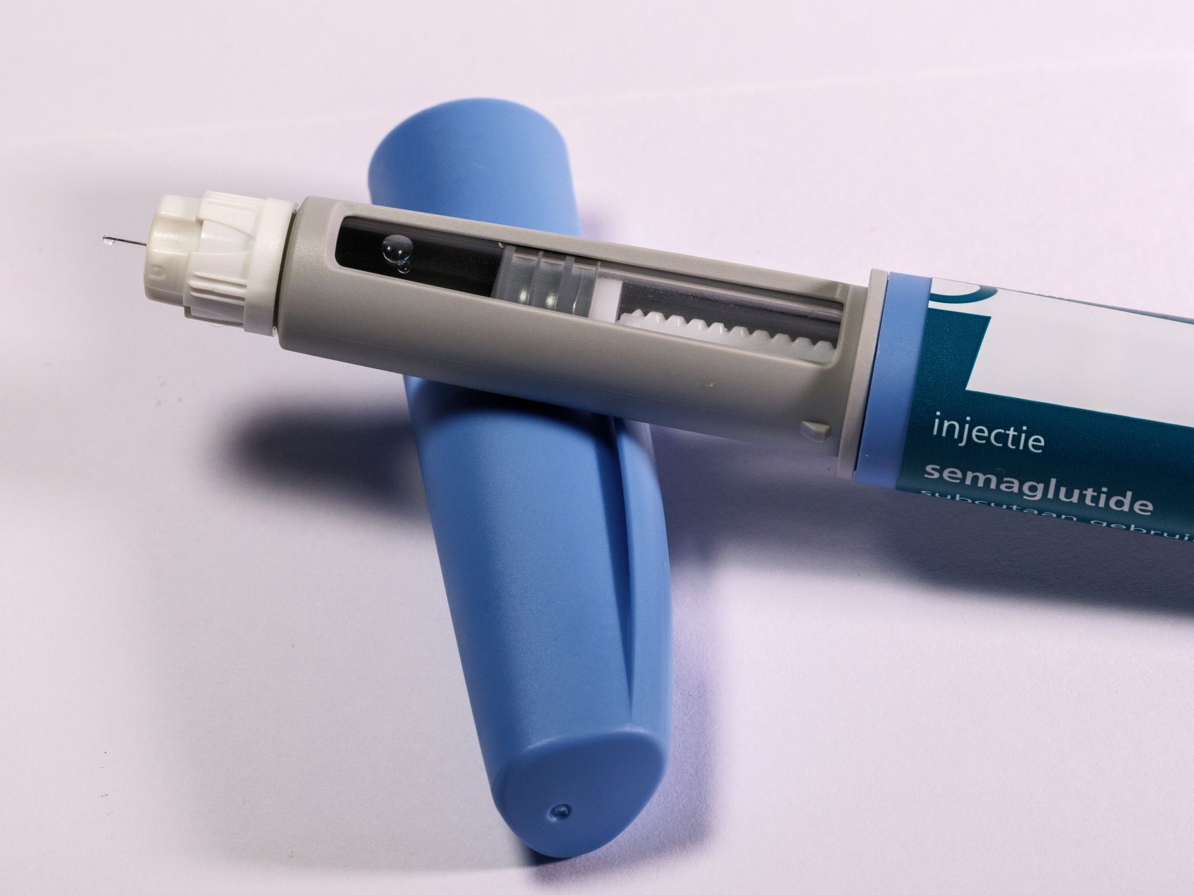 A semaglutide injection pen on a plain clinical surface
