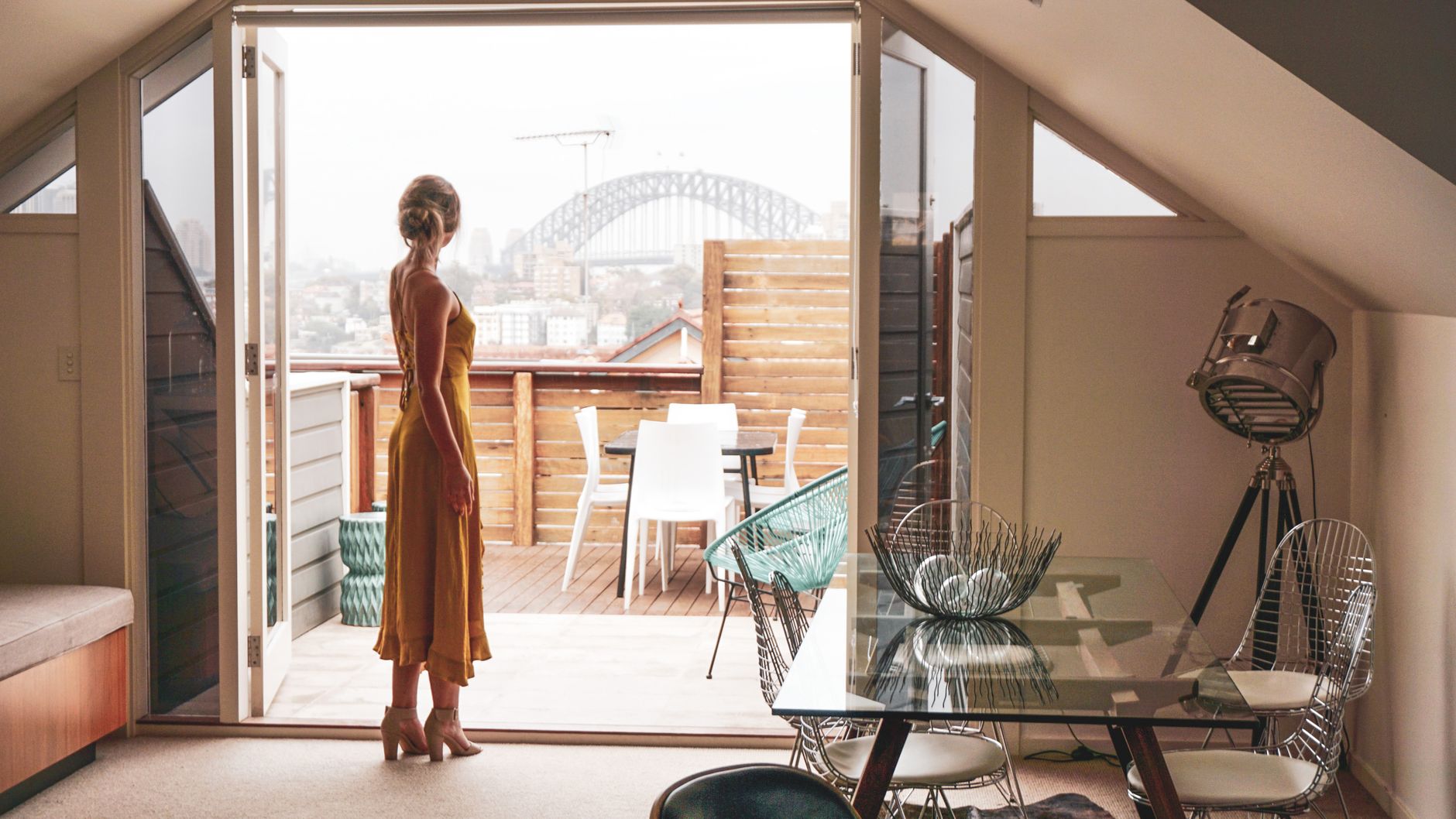 Woman in an elegant dress looking out towards the Sydney Harbour Bridge