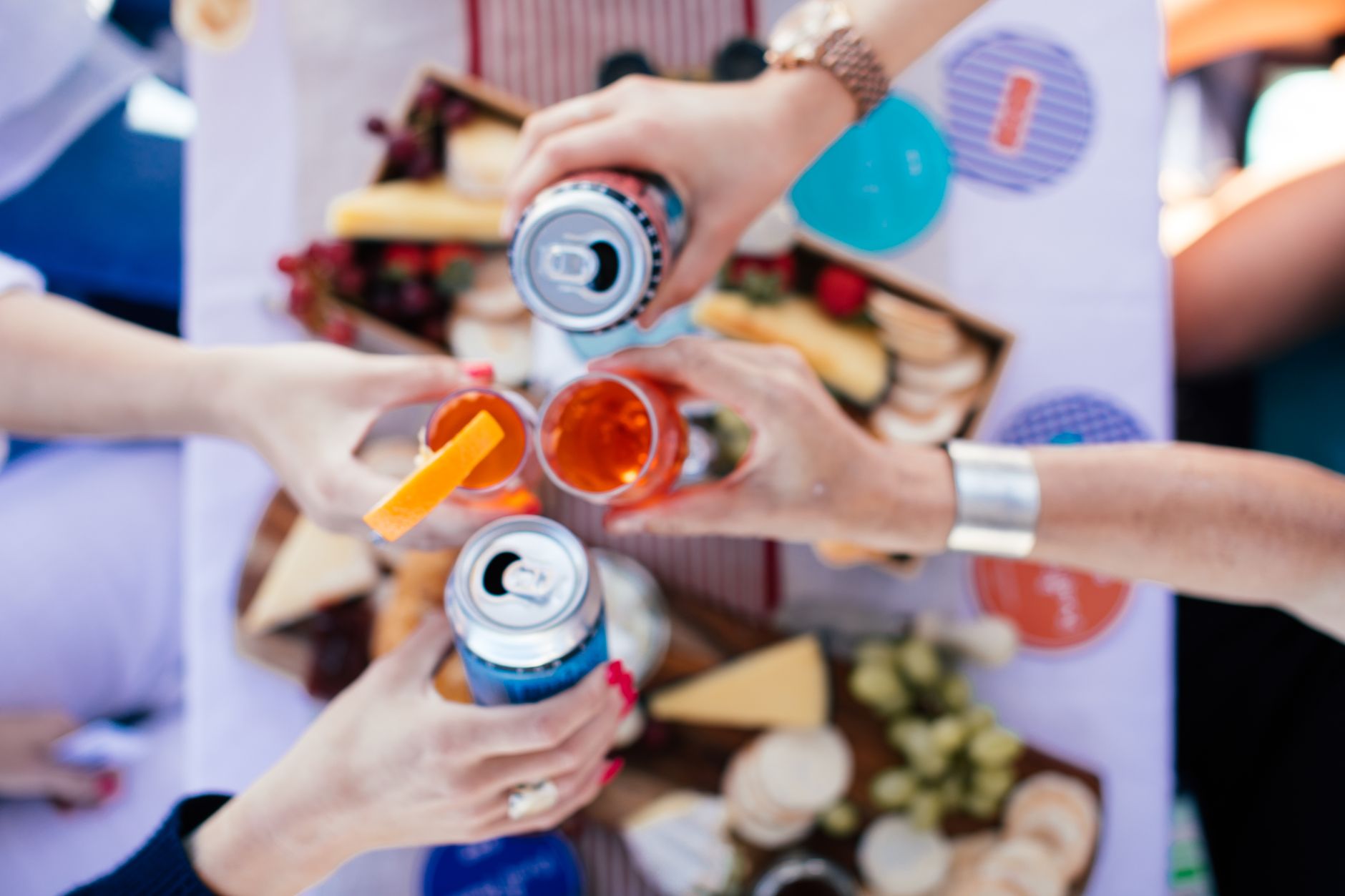 Cans of wine and a glass on a table, reflecting the shift from novelty packaging to a credible everyday pour.